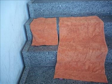Abbildung: 1 Set ungenutzte flausch. dunkelorangene Handtücher 